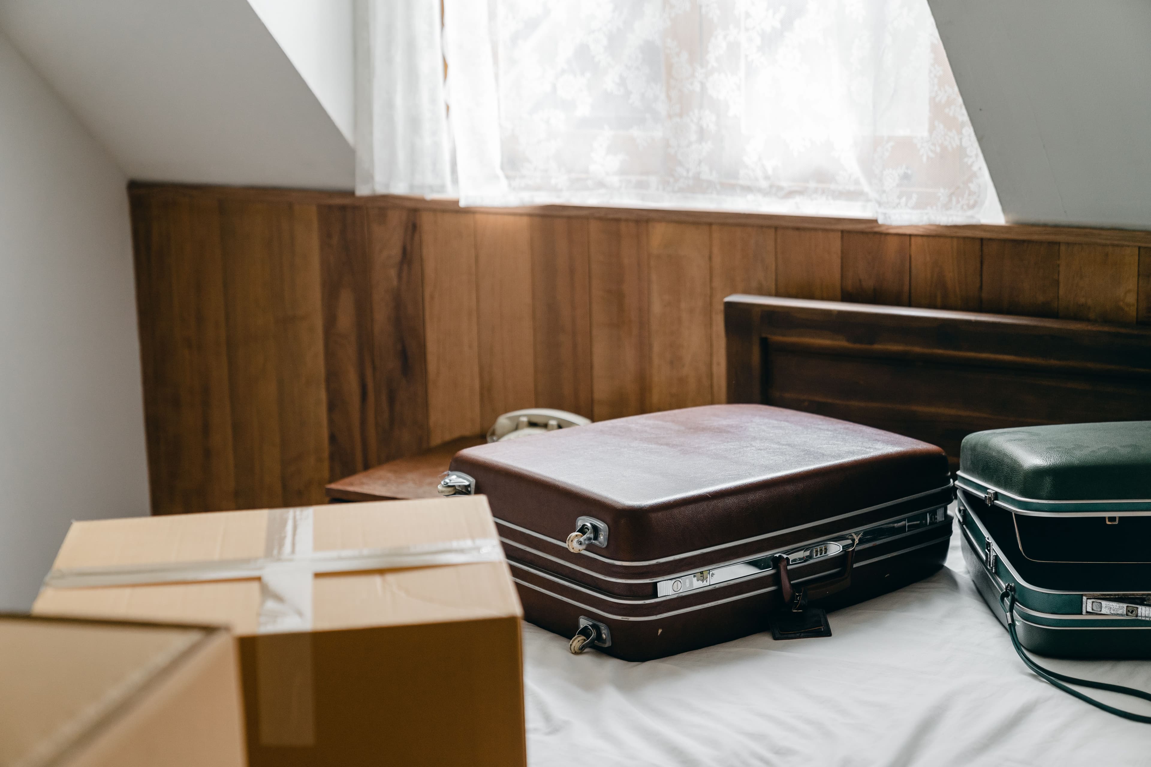 Suitcase and neatly organized seasonal clothing in a small NYC apartment